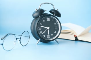 Clock, Book, and Glasses against a light blue backgroundPhoto by Towfiqu barbhuiya on Unsplash